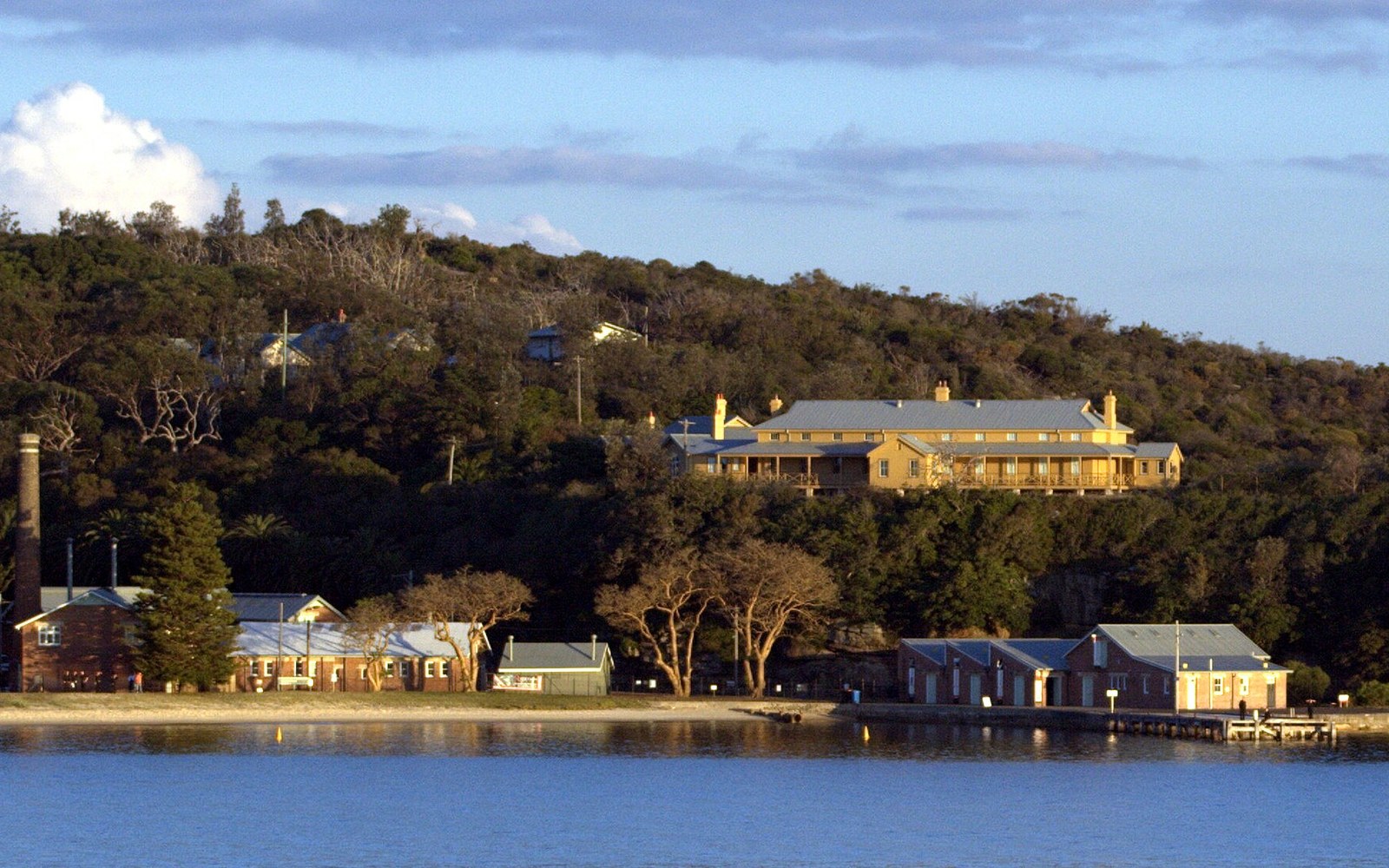 Weatherboard isolation ward buildings at Q Station on the North Head headland in late afternoon light